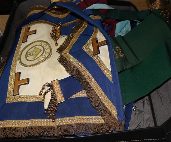 A collection of Masonic regalia from a London lodge, including eight various aprons, sashes, cuffs, etc.